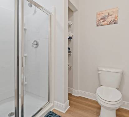 Bright and spotless bathroom vanity with granite countertop, large mirror, and extra storage. Thoughtfully stocked with essentials and fresh towels for a comfortable, convenient stay