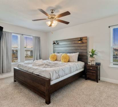 Relax in this serene bedroom featuring a plush bed, stylish wood headboard, smart TV, and soft natural light. Thoughtfully designed for comfort and rest, it&rsquo;s the perfect retreat after a day of adventure or work.