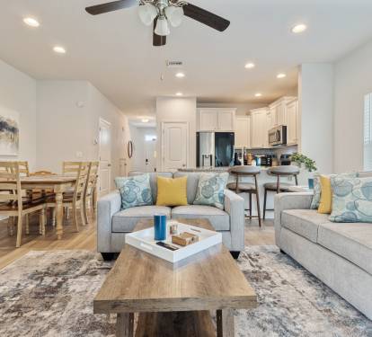 Bright, modern open-concept home with a cozy living area, stylish furnishings, and fully equipped kitchen. Enjoy comfortable seating, dining space, and natural light perfect for relaxing, working remotely, or hosting a memorable stay.