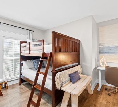 Second bunk room with two full-over-full bunks plus a dedicated desk for remote work or school. Perfect mix of fun and function.