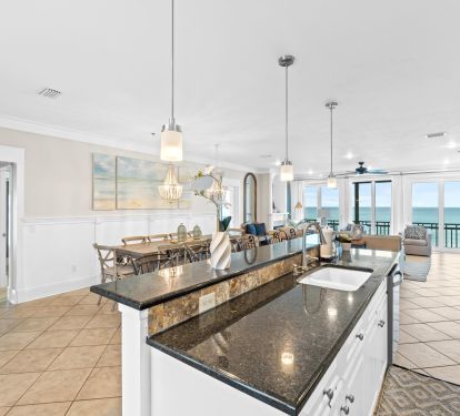 Entertain in style in this open-concept kitchen and living space, designed with modern touches and sweeping Gulf views. Whether cooking, relaxing, or hosting, this space keeps everyone connected.