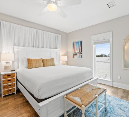 Bright 3rd king bedroom with coastal d&eacute;cor and plush bedding. Relax in comfort and enjoy peaceful mornings before stepping out to explore the beach just steps away. Perfect for couples or parents.