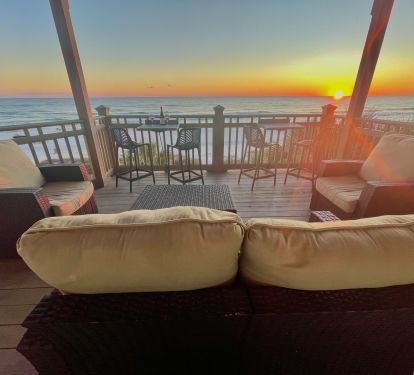 Cozy lounge seating with unobstructed sunset views. Enjoy cocktails, conversation, or simply relax as the sky turns brilliant shades of orange and pink. The ultimate beachfront retreat for couples or groups.