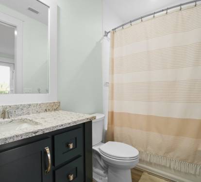 bunk room bathroom with tub and shower