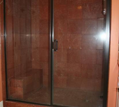 walk-in tiled shower with bench in master bathroom