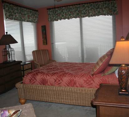 bedroom 2 with queen bed and doors to access balcony