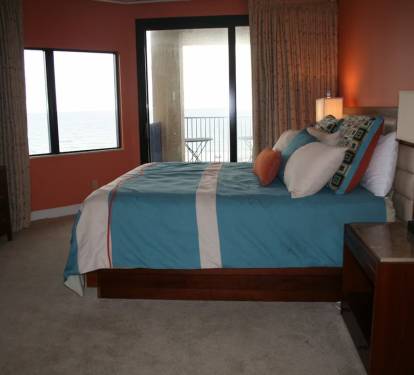 master bedroom with California king size bed and direct access to balcony