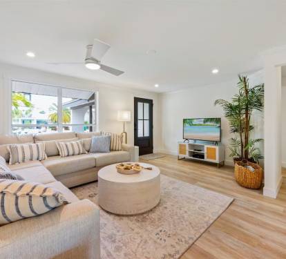 Sirenia By The Sea - Front Living room with large sectional sofa and TV