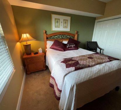 Queen-sized bedroom with soft carpet and ample storage space to store your belongings.