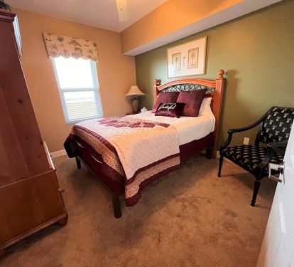Queen-sized bedroom with soft carpet and ample storage space to store your belongings.