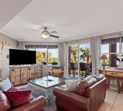 Living room with leather couches, large smart tv.