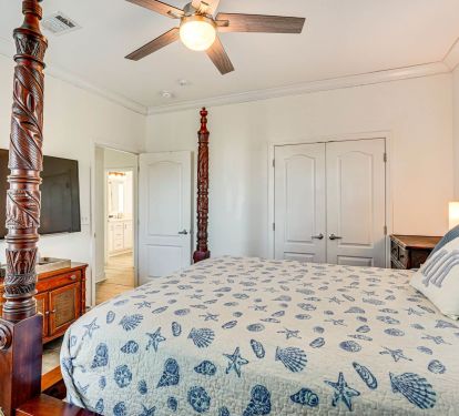 Four Post Bed with fan and TV.