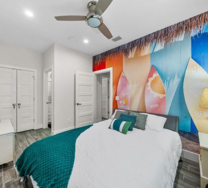 2nd bedroom with Queen bed, linens, pillows, smart TV, fan, closet, 1 roll away single bed is stored in the closet. Bathroom attached.