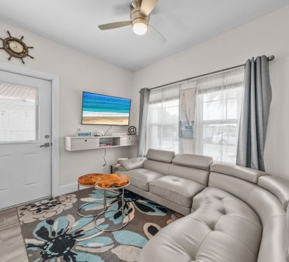 Living room couch with Smart TV and live wood side table, books