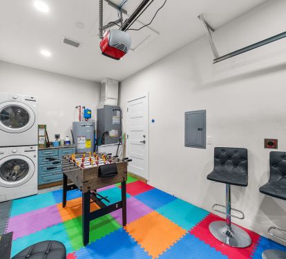 Garage -> Game room with Game table, Corn hole, pacman arcade