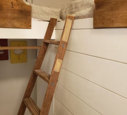 Front bunk room. Both bunks are upper bunks and have plugs and cubbyholes.