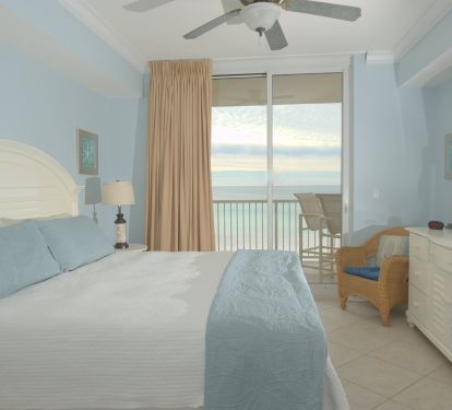 The spacious primary bedroom has a king bed and direct access to the balcony. 