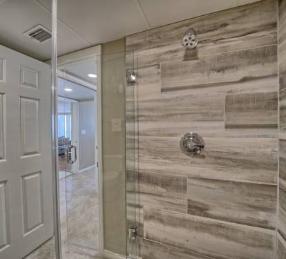Check out the large walk in shower with new tile and glass door