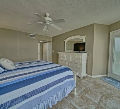 Door opens to oversized balcony with bistro table and high back chairs. Modern!