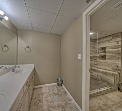 Modern spa like bathroom with new tile, double vanity and one of two master bath