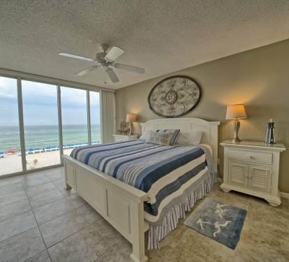Large dresser, king bed, and 2 size stands, large mounted TV. Door opens to deck