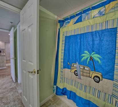 Fun beach themed master bath with oversized step in shower/tub.