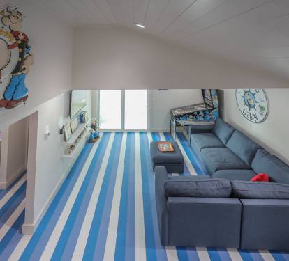 Unique Popeye-inspired space with bold striped floors clean, fun!