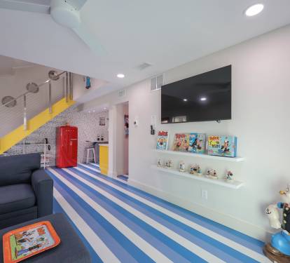 Bright, coastal-style space with blue and white striped floors for a fun, beachy vibe.