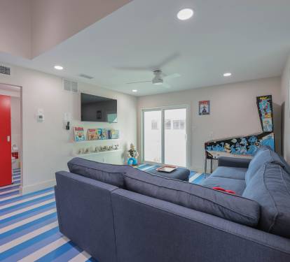 Entertainment corner featuring the Popeye pinball machine and themed d&eacute;cor for a one-of-a-kind stay.
