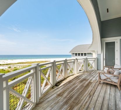 Step onto your private oceanfront balcony and soak in stunning beach views while relaxing in comfortable seating.