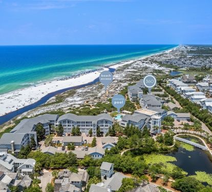 Aerial view of beachfront community with pristine white sand beaches and emerald waters along the Gulf Coast