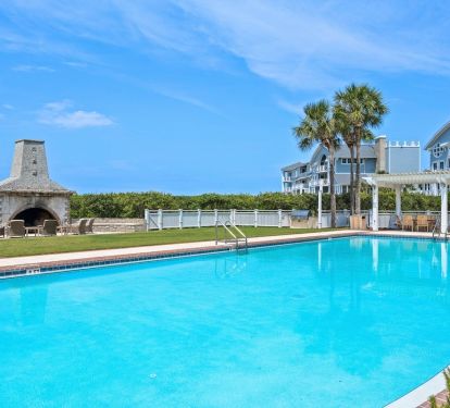 Dive into crystal-clear waters while enjoying the tropical palms and stone fireplace that make this poolside paradise your perfect escape.