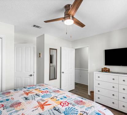 Large mounted TV with cable and you tube, and door to bathroom
