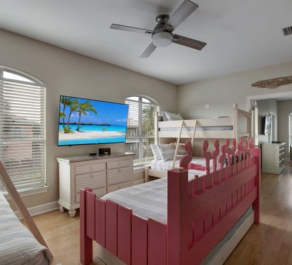 Bunk room with playful pink bunks and Smart TV