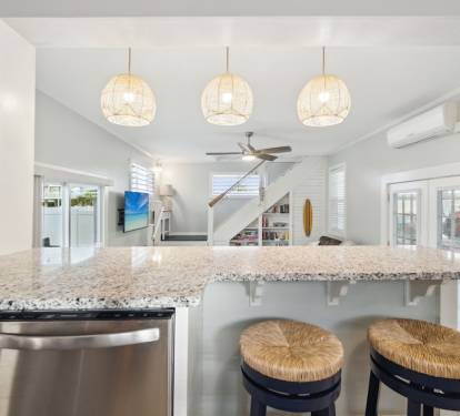 Dining table seats up to 6 guests with six bar stools surrounding the bar.