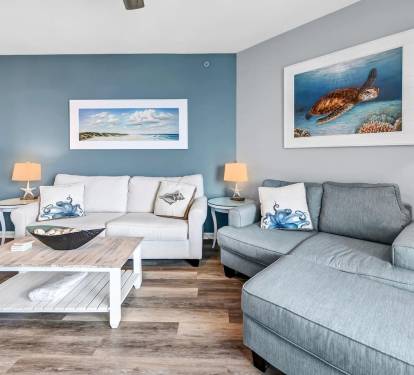 Coastal living room w/ plush sofas, ocean-inspired art, & a relaxed layout made for unwinding