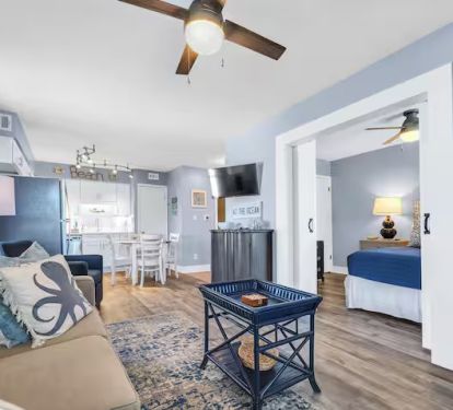 Open-concept living area connecting to kitchen and bedroom