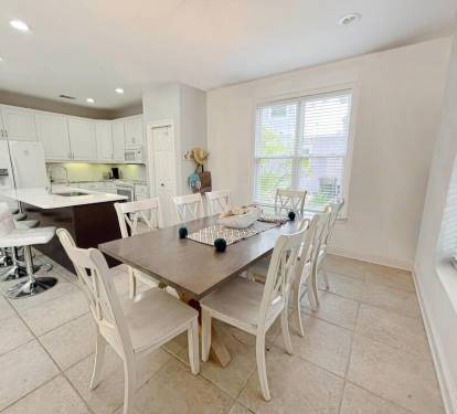 Comfortable seating for 12 with 8 at dinner table and 4 at kitchen island