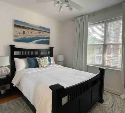 Large windows bring in natural light and blackout curtains make it go away for a restful sleep.