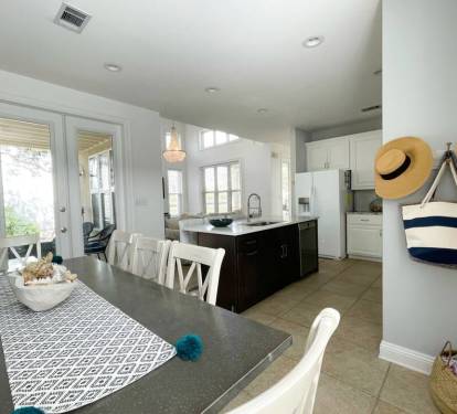 Double doors lead to a covered porch and the backyard. 