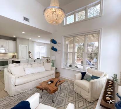 Relax in the living room surrounded by windows and filled with light. Enjoy views of the back yard