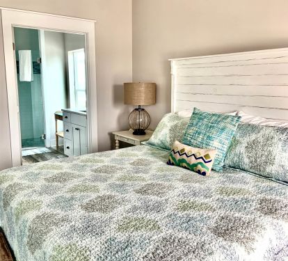 Top level King suite with a private balcony. Custom-made head board of reclaimed wood