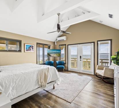 Airy master bedroom with breath-taking views, sitting area and access to private balcony.