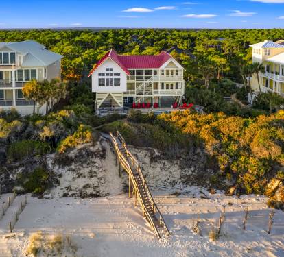 Step out onto the deck and follow the path to the sandy beach, where the ocean awaits.
