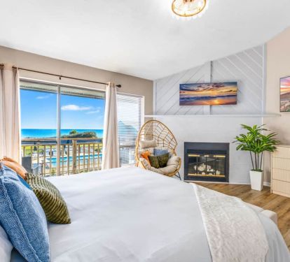 In the master suite, unwind with a 55&rdquo; TV, pool-and-beach view deck, egg chair, and king bed.