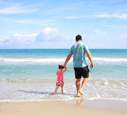 Dad and daughter enjoying the beach