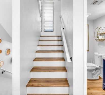 Up the stairs to the queen guest room and full bath&mdash;artsy walls, bright and welcoming.