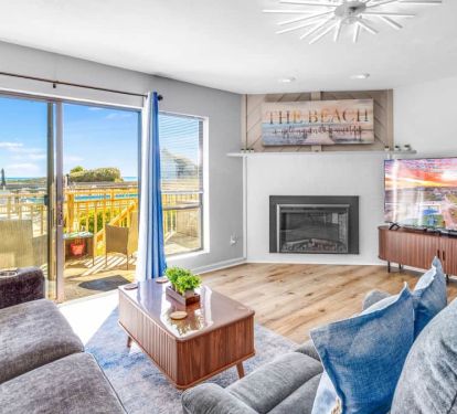 Beautiful living room: big TV, electric fireplace, deck views, USB/C plugs, queen pullout sofa.