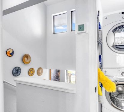 Looking at 3rd floor landing with laundry access and boho stairwall d&eacute;cor&mdash;bright, breezy, and easy.