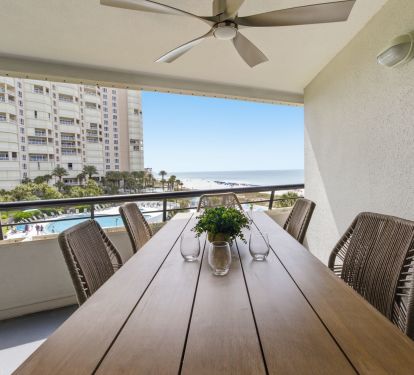 Balcony dining overlooking the pool and gulf